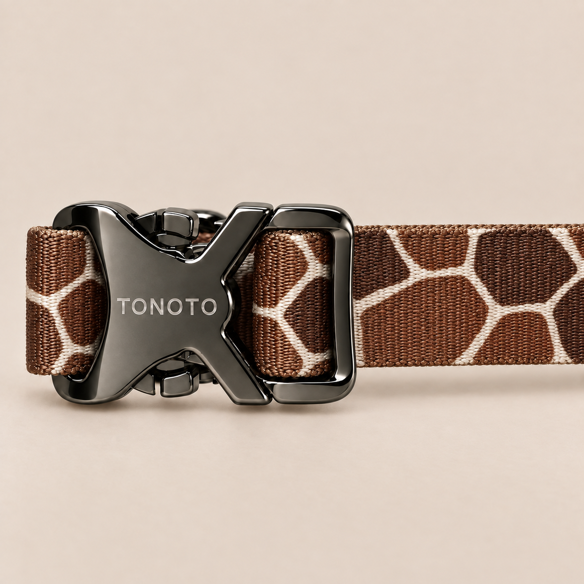 Close-up of TONOTO buckle on giraffe pattern collar