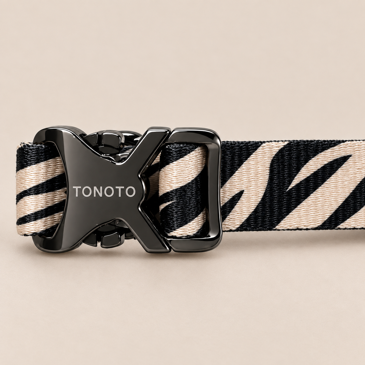 Close-up of TONOTO buckle on zebra pattern collar