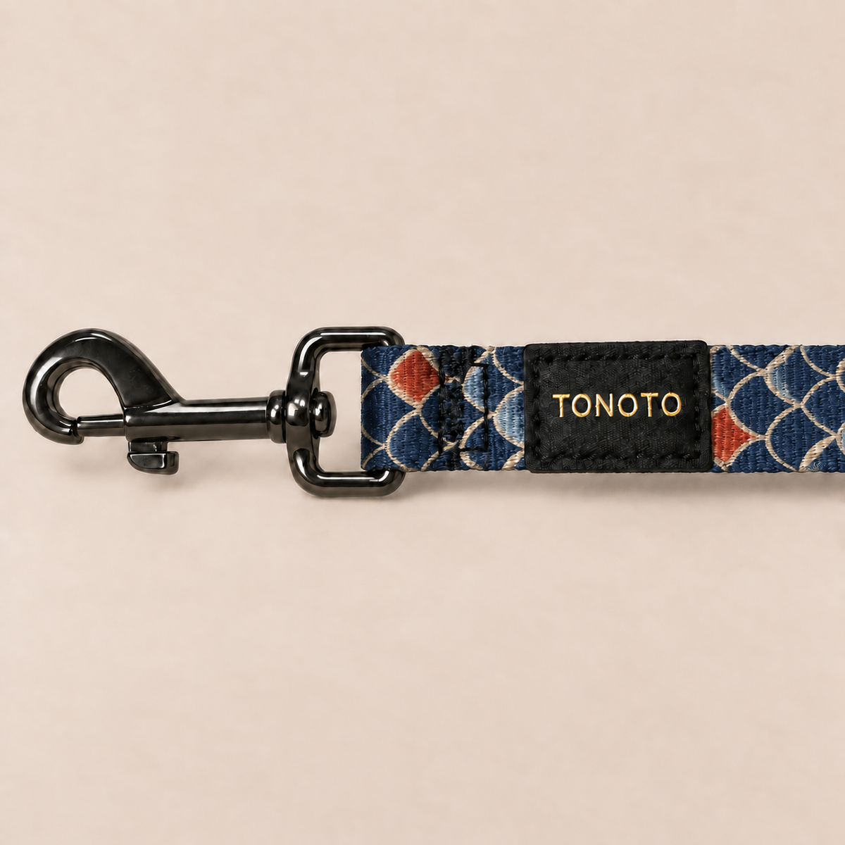Close-up of koi pattern dog lead snap hook and TONOTO label