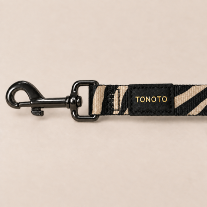 Close-up of zebra pattern dog lead snap hook and TONOTO label